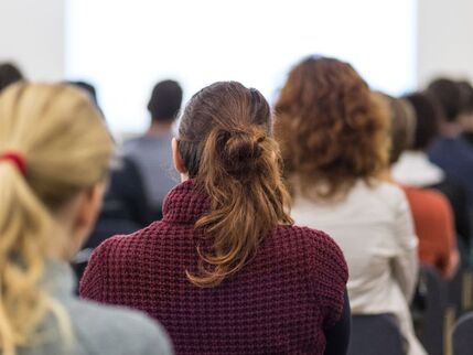 Back of a womans head at a workshop